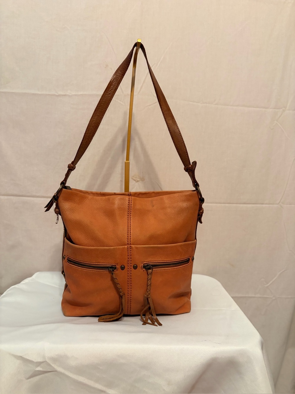 The Sak Ashland Bucket Bag in a tobacco brown leather.